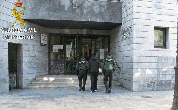Uno de los detenidos, al entrar en los juzgados. /Guardia Civil