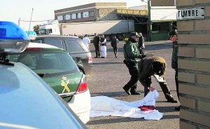 El cadáver del vigilante tapado con una sábana en la puerta de la empresa. :: IRENE MARSILLA/