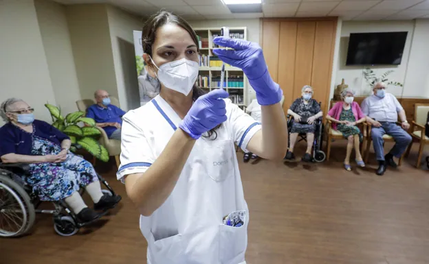 Trabajadores de la salud preparan una dosis de vacuna contra el Covid-19.